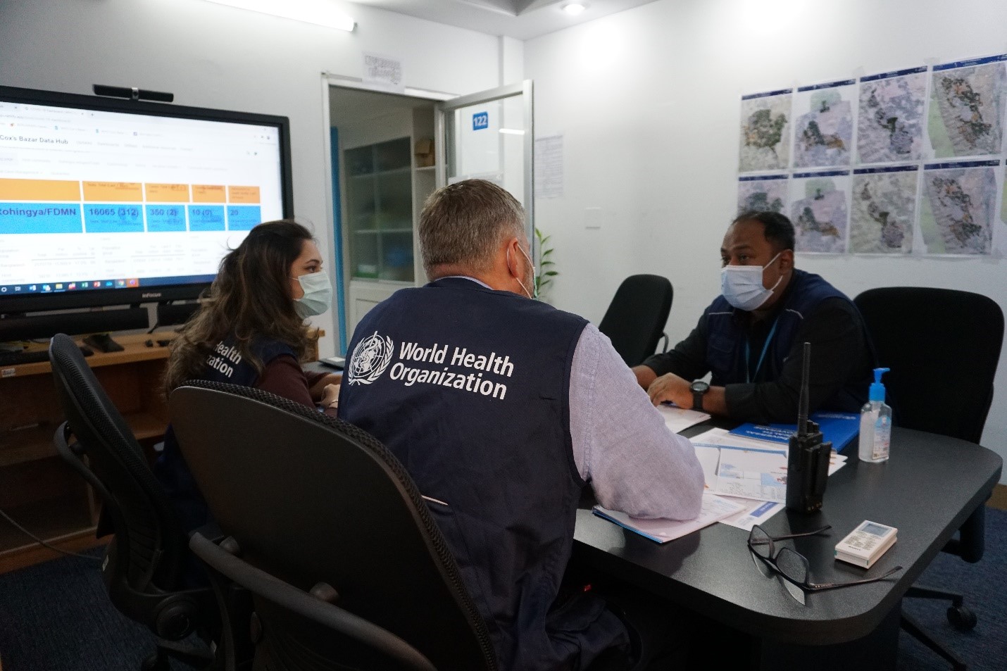 WHO Head of Sub-Office, Dr Kai von Harbou, with WHO Epidemiology Team Lead, Dr Muhammad Khan, and WHO National Consultant Dr Tasnova Sadneen, during a COVID-19 outbreak update in Cox’s Bazar. WHO Bangladesh/Tatiana Almeida.